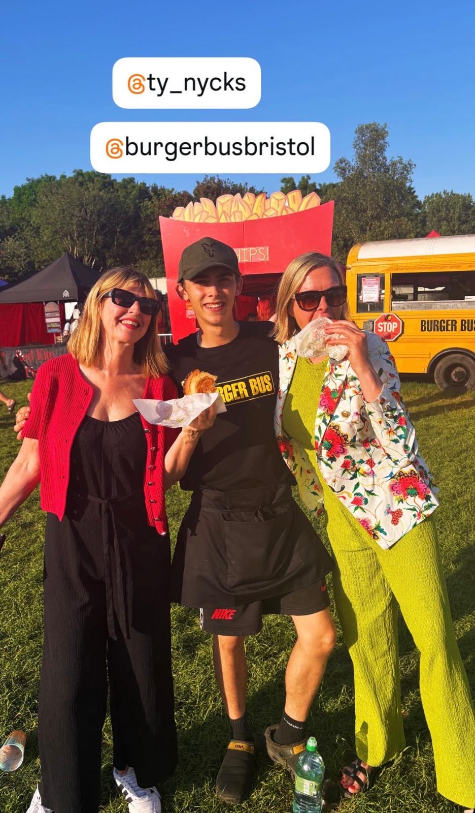 Tyler with two happy customers holding burgers